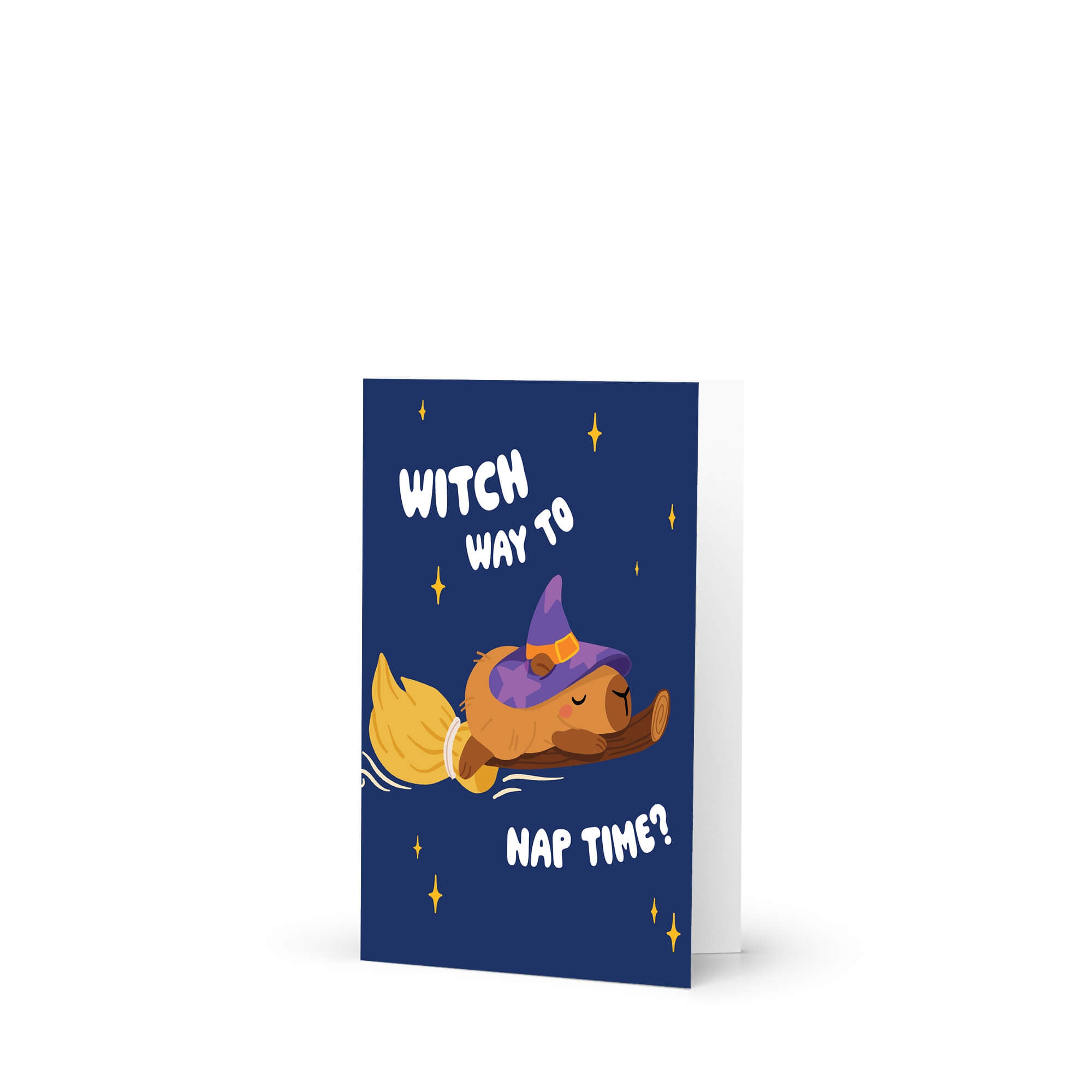 cute Halloween-themed greeting card with a capybara in a witch hat and broom, text 'Witch way to nap time?' on a blue background