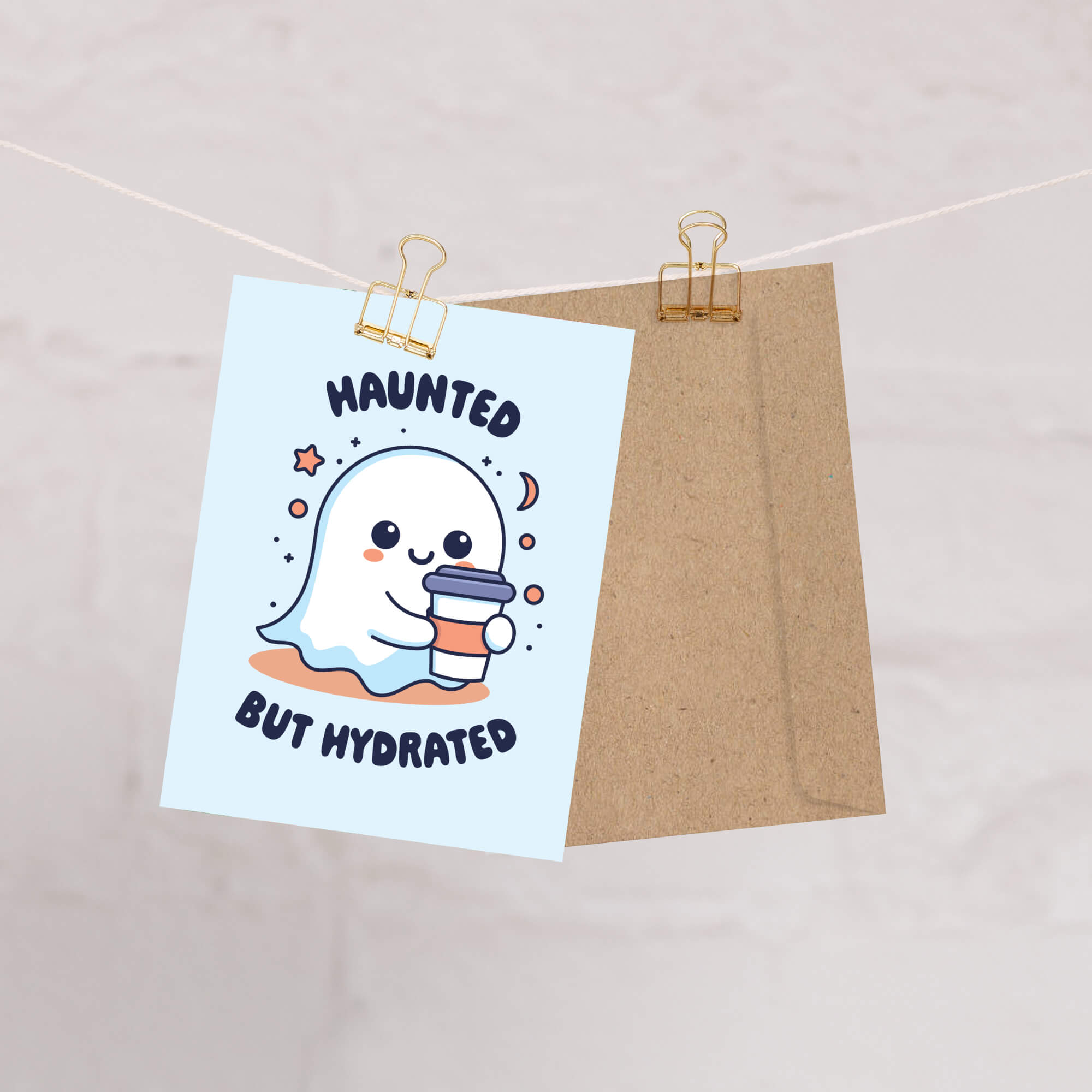 kawaii halloween Greeting card with a ghost holding a cup and 'Haunted But Hydrated' text on a light blue background.