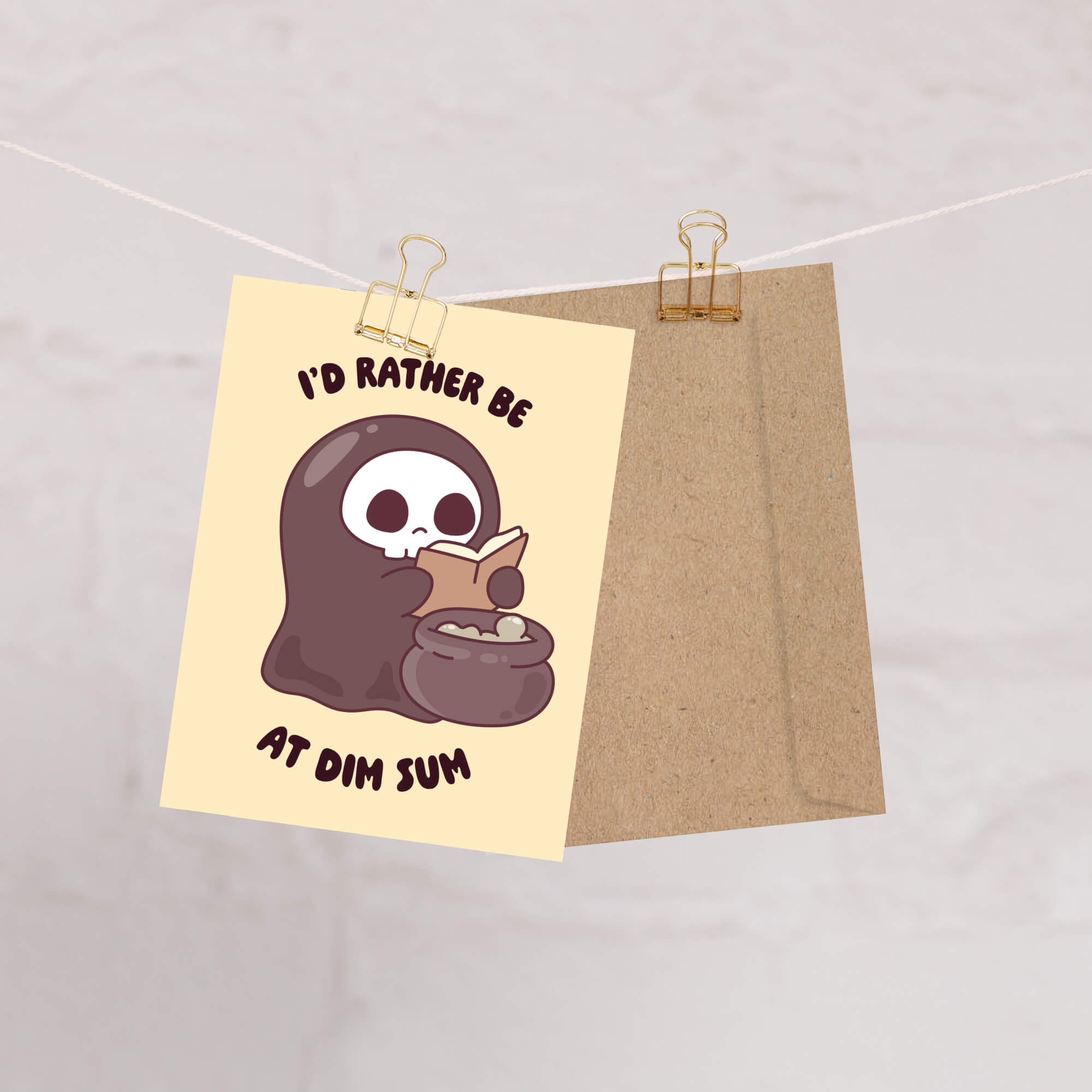 funny halloween Greeting card with a kawaii grim reaper holding a cauldron and text 'I'd rather be at dim sum' on a beige background.