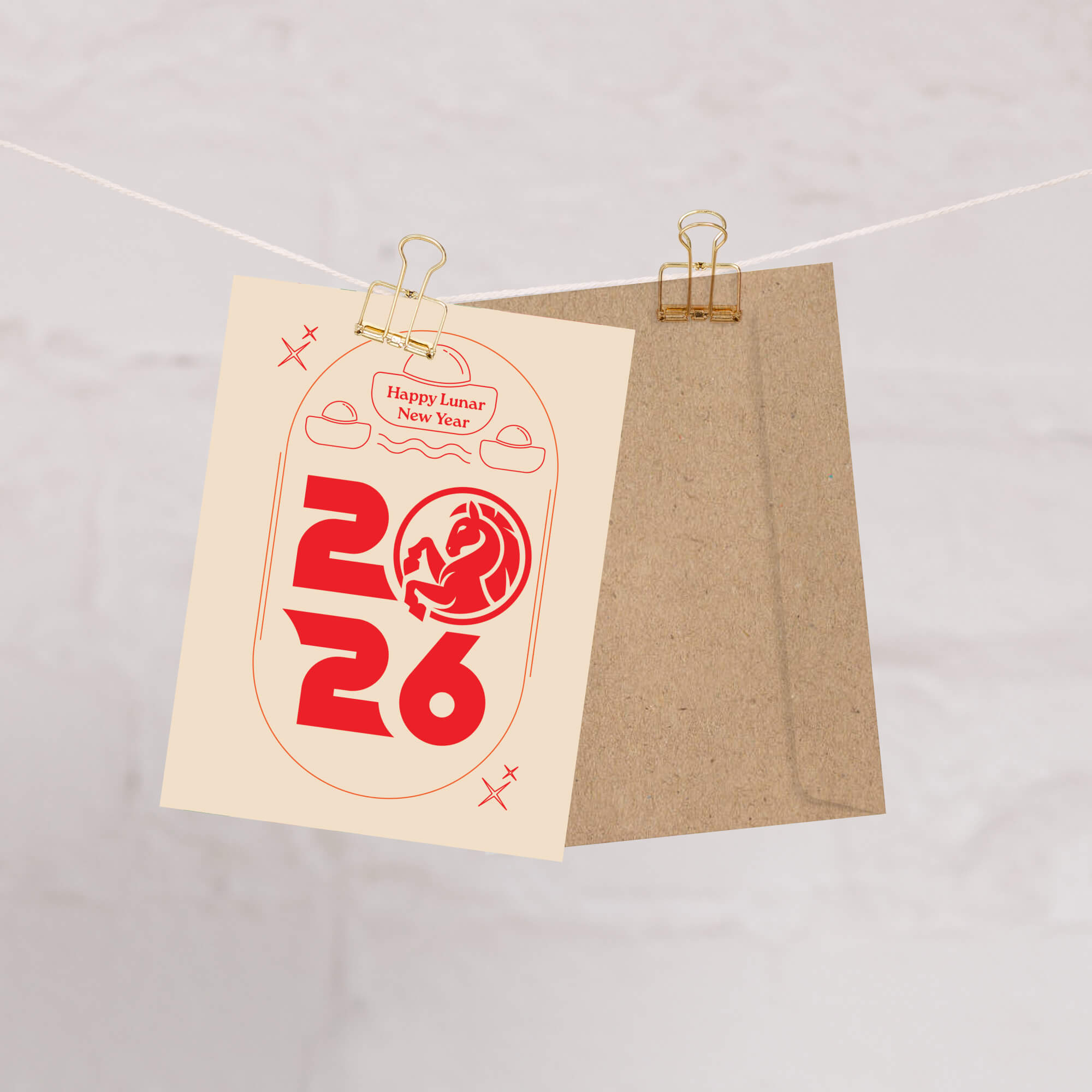 chinese greeting Card with 'Happy Lunar New Year 2026' text and design on a beige and brown cardstock, clipped to a string.