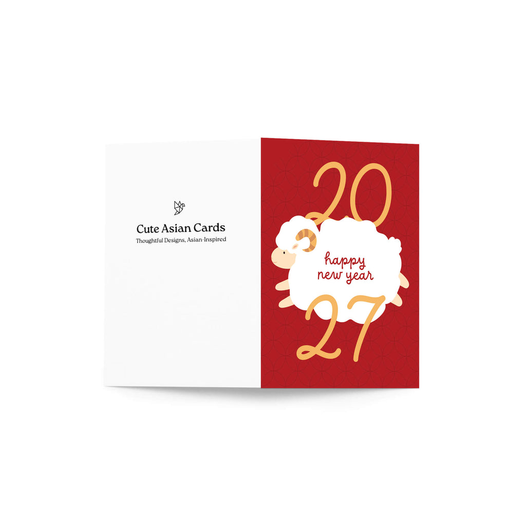 A folded lunar new year card shown open against a white background. The right panel is dark red with gold numbers '20' and '27' and a white sheep illustration with the words 'happy new year' in red script.