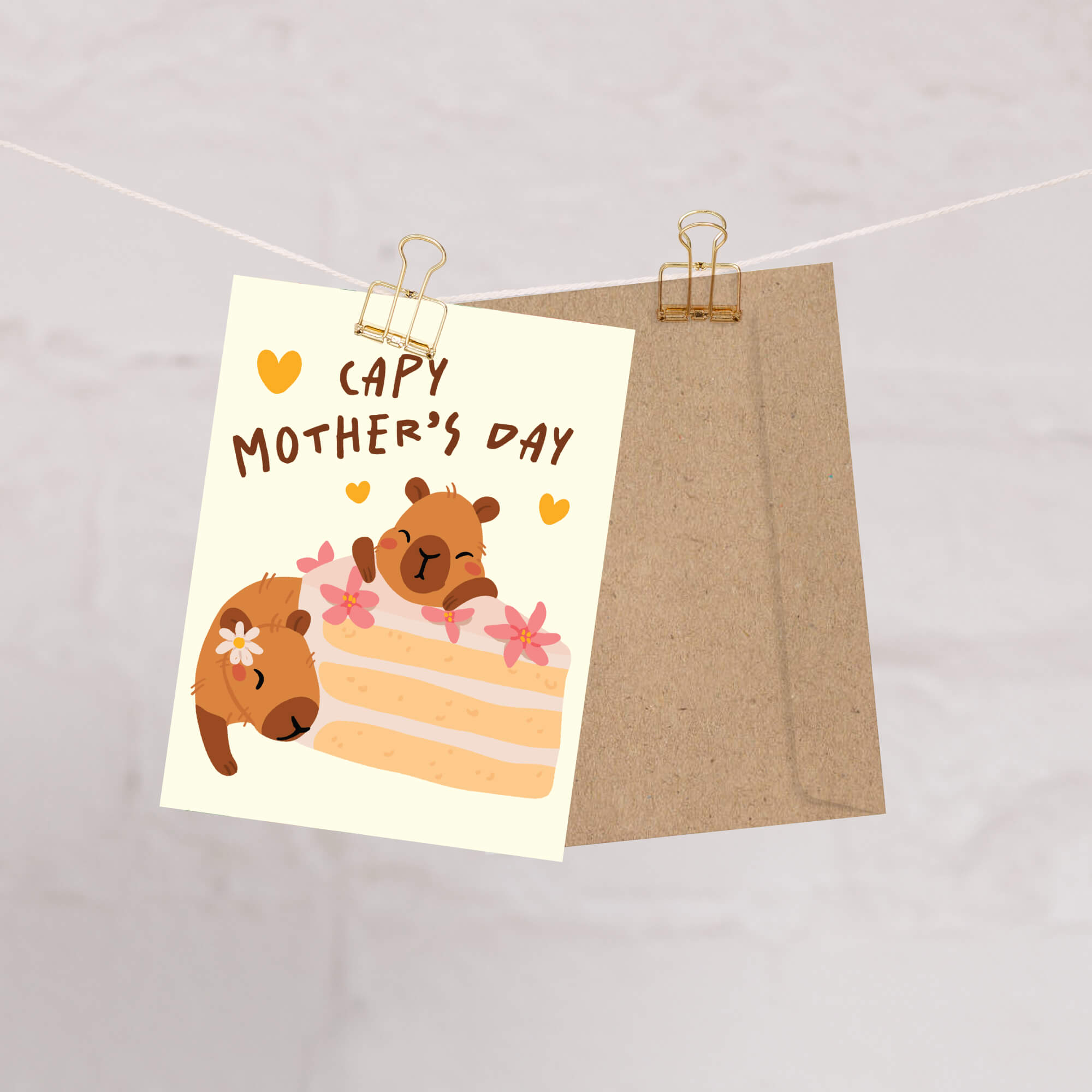 Mother's Day card with cute capybara animals around a cake light on a light yellow background with funny pun message: capy mother's day surrounded by hearts