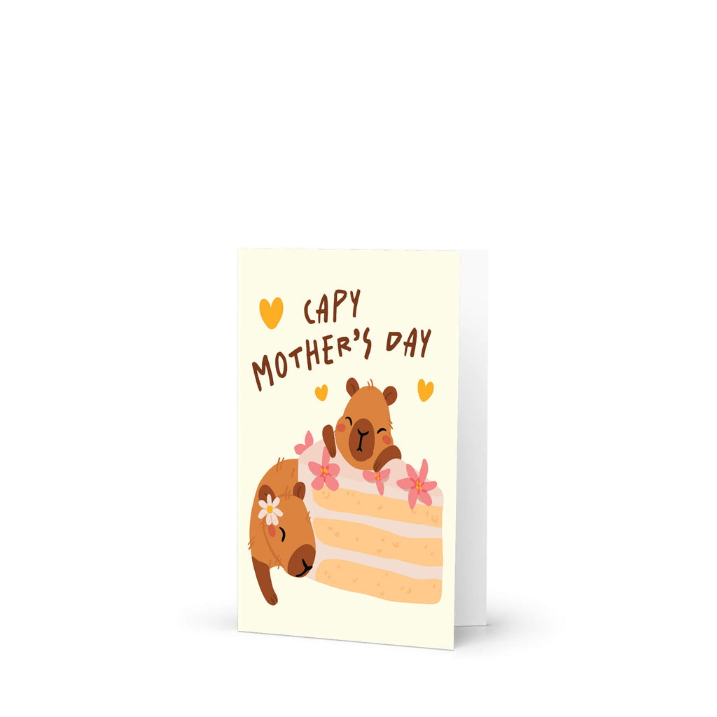 Mother's Day card with cute capybara animals around a cake slice on a light yellow background with funny pun message: capy mother's day surrounded by hearts