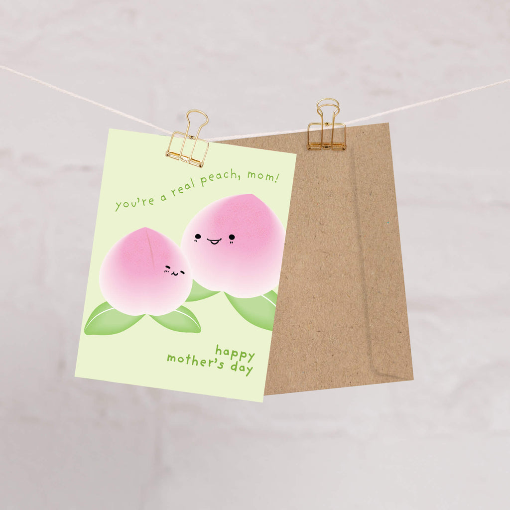 happy Mother's Day card with asian white peaches and text on a light green background that says youre a real peach, mom for a funny food pun message