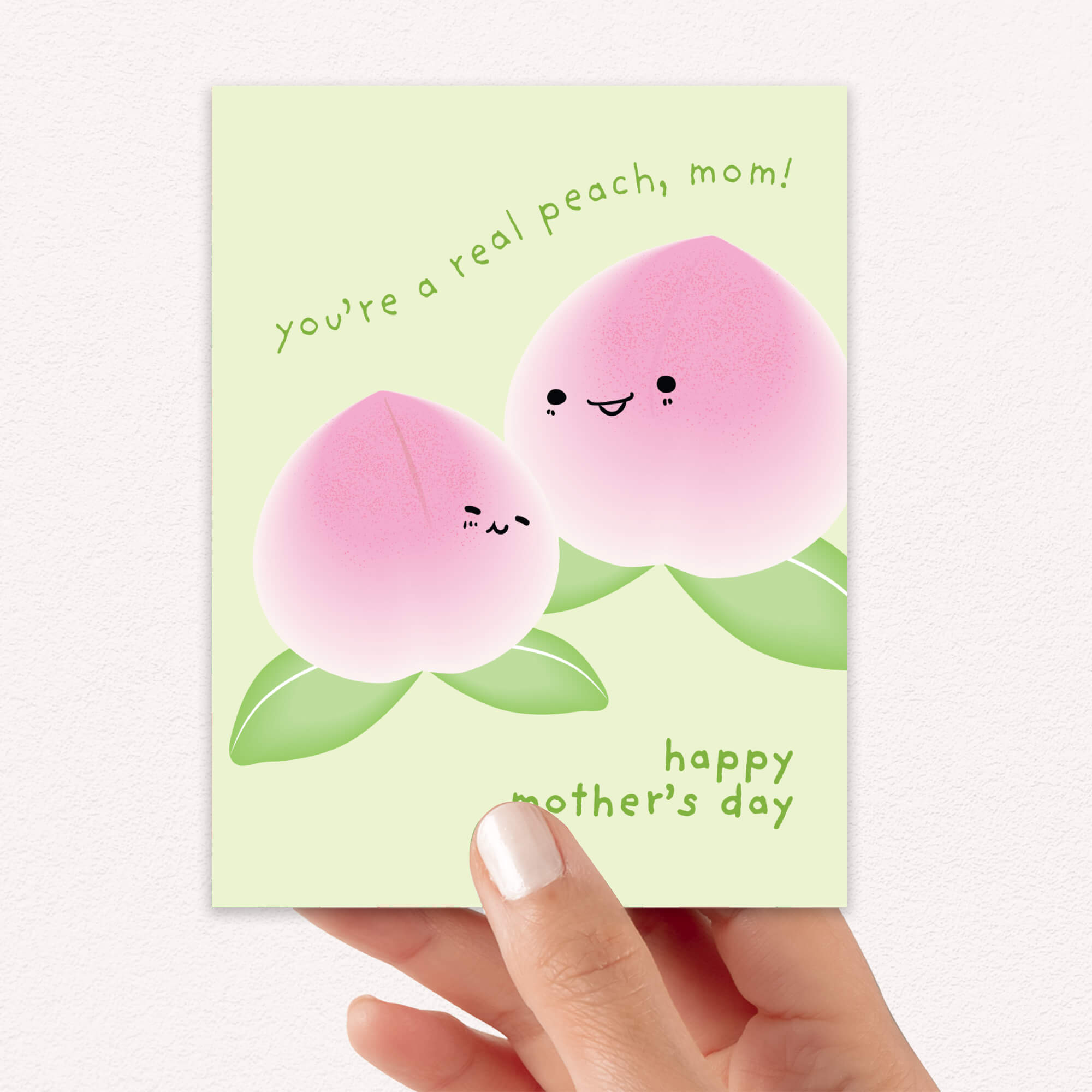 happy Mother's Day card with asian white peaches and text on a light green background that says youre a real peach, mom for a funny food pun message
