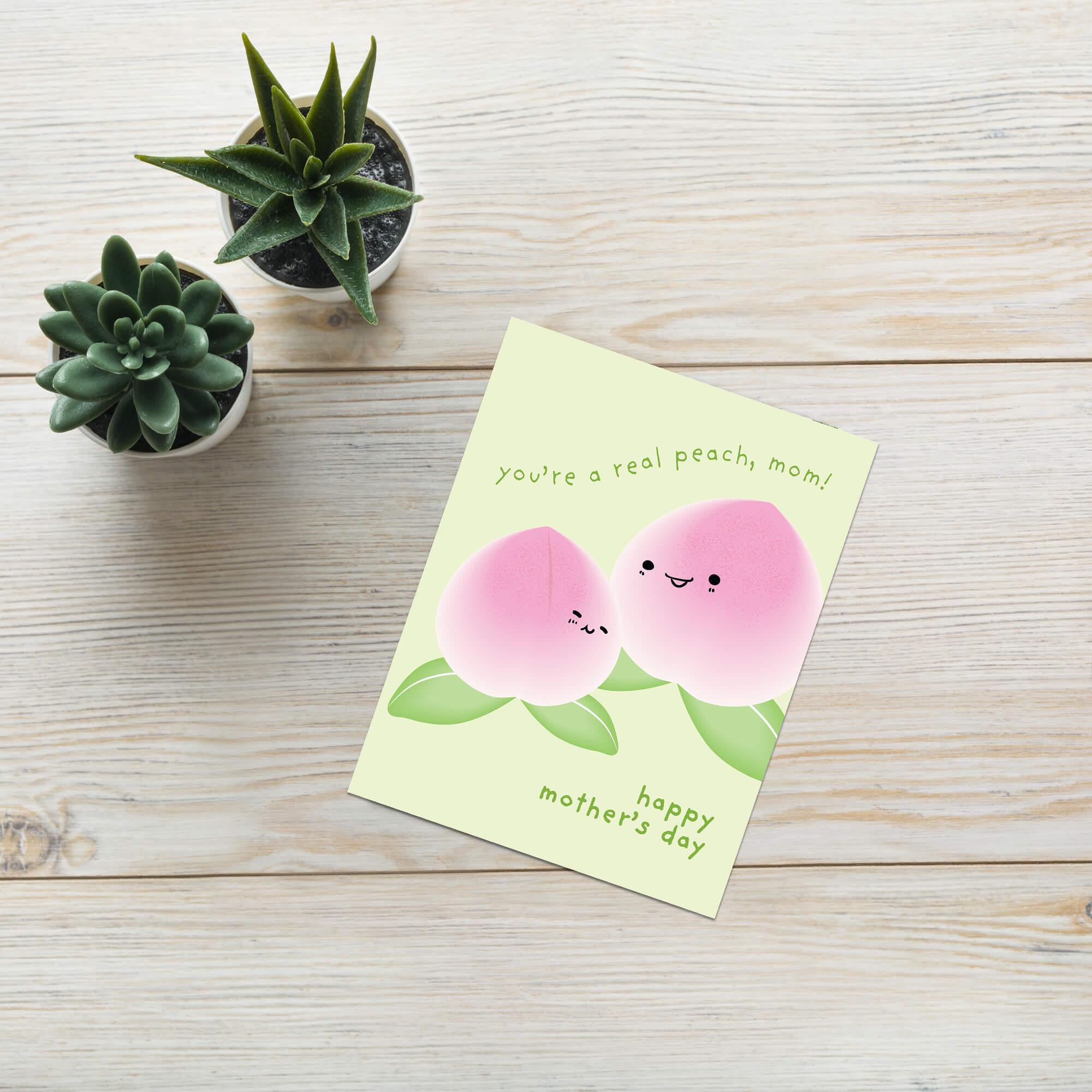 happy Mother's Day card with asian white peaches and text on a light green background that says youre a real peach, mom for a funny food pun message