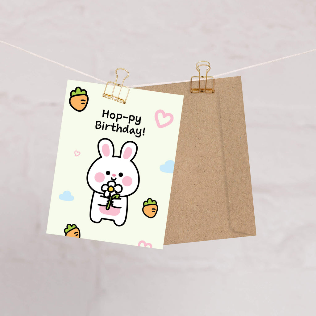 Cartoon rabbit birthday card with 'Hoppy Birthday!' text on a white background.