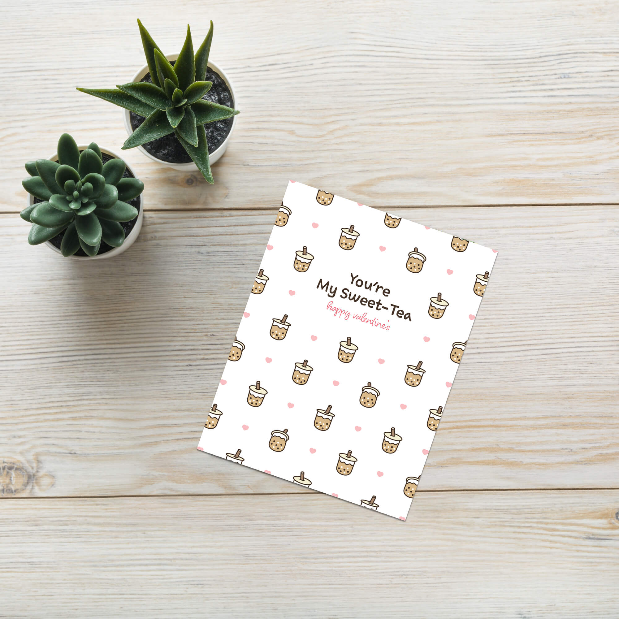 valentines day card with Pattern of small boba cups with hearts and the line “You’re My Sweet-Tea.”