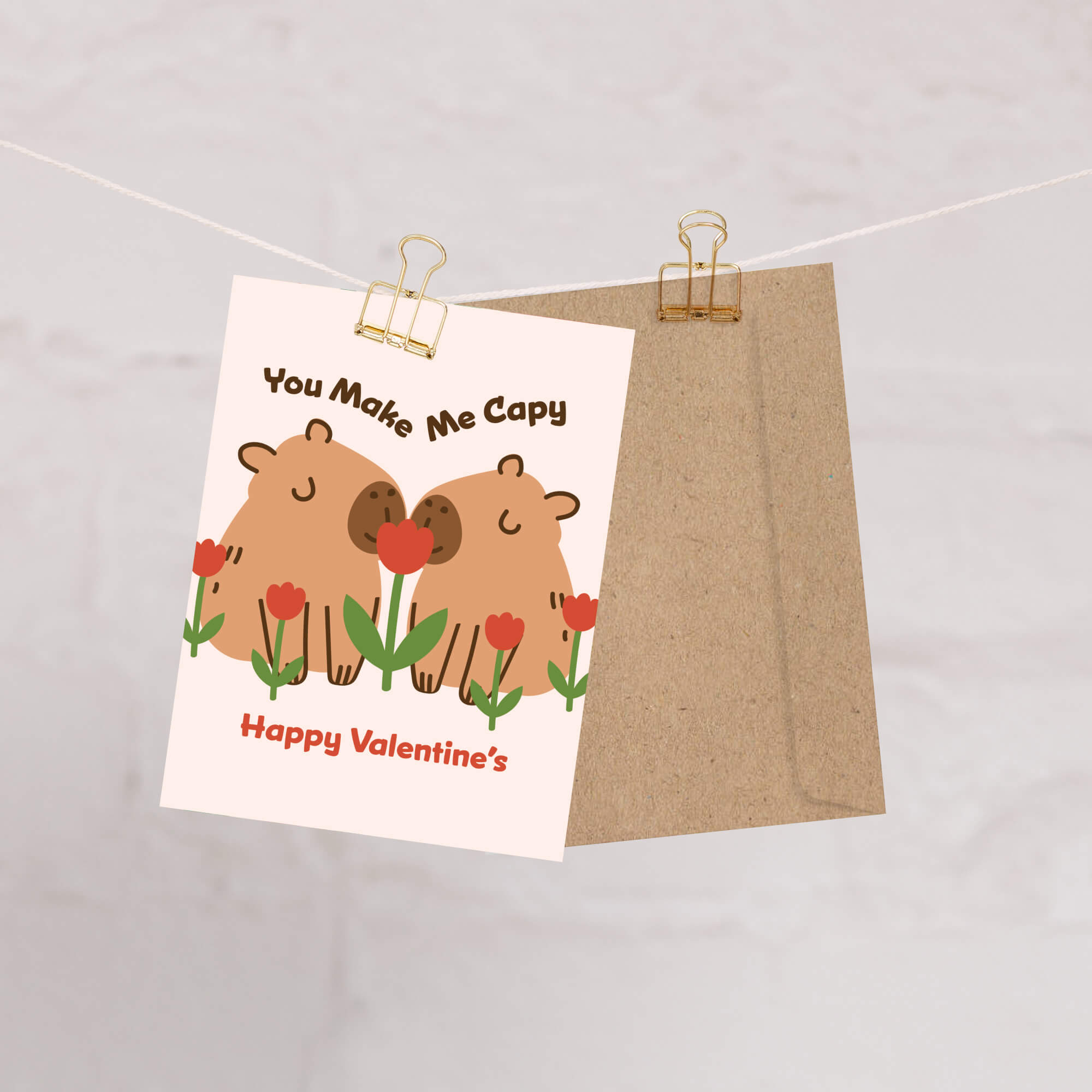 Two capybaras with tulips; curved text “You Make Me Capy” and “Happy Valentine’s.”