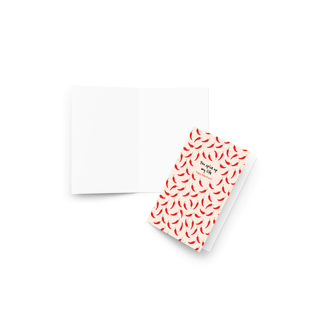 light pink valentines day card with repeating red chilies and center text “You spice up my life — Happy Valentine’s.”