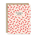 light pink valentines day card with repeating red chilies and center text “You spice up my life — Happy Valentine’s.”