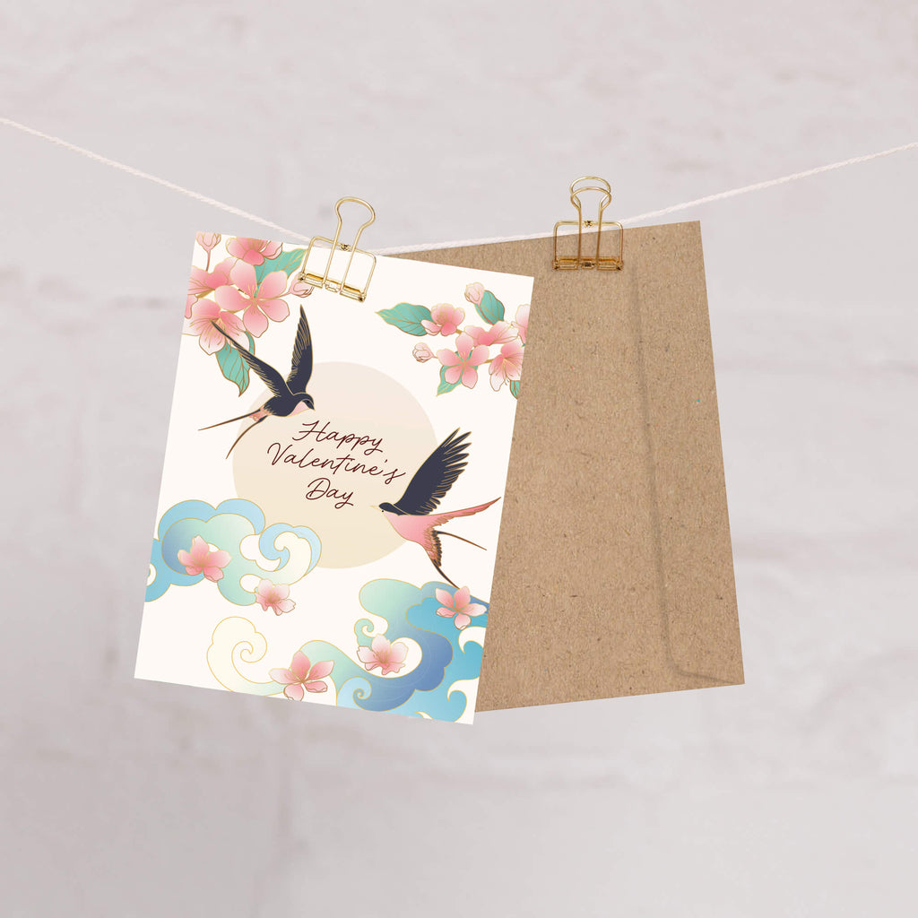 Valentine's Day card with birds and flowers on a string with a brown envelope.
