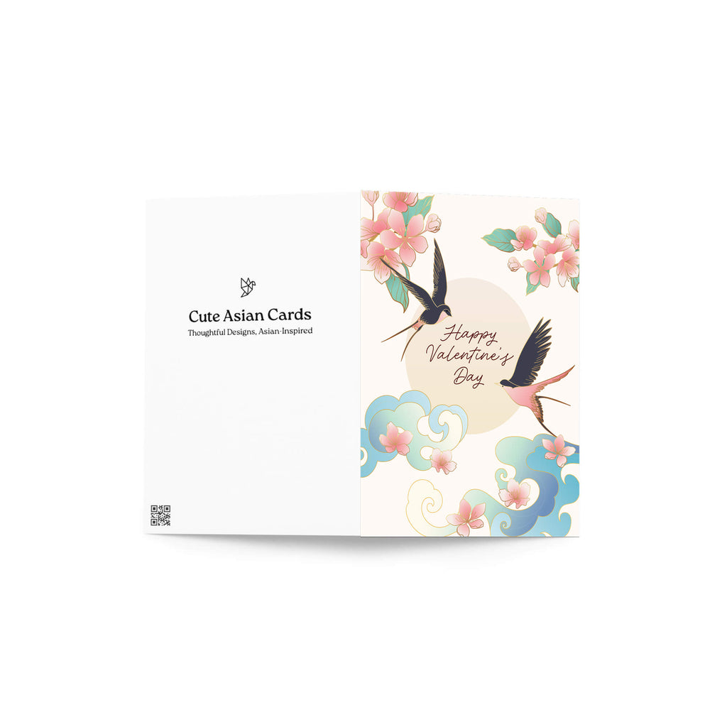 Two swallows flying near blossoms and pale sun with “Happy Valentine’s Day.”
