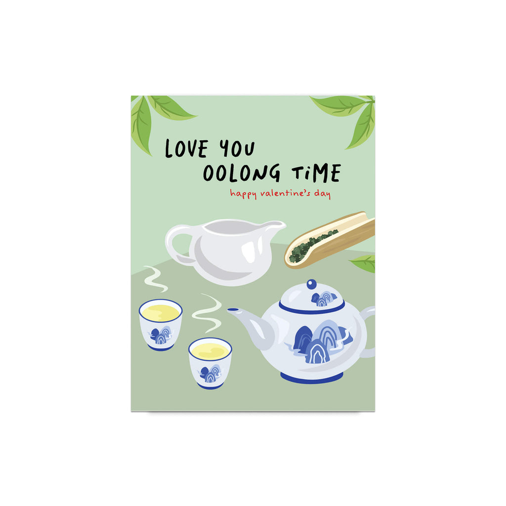 asian inspired valentintues day card with White and blue china teapot, cups, and oolong loose leaf tea on soft green; text “Love you oolong time.”