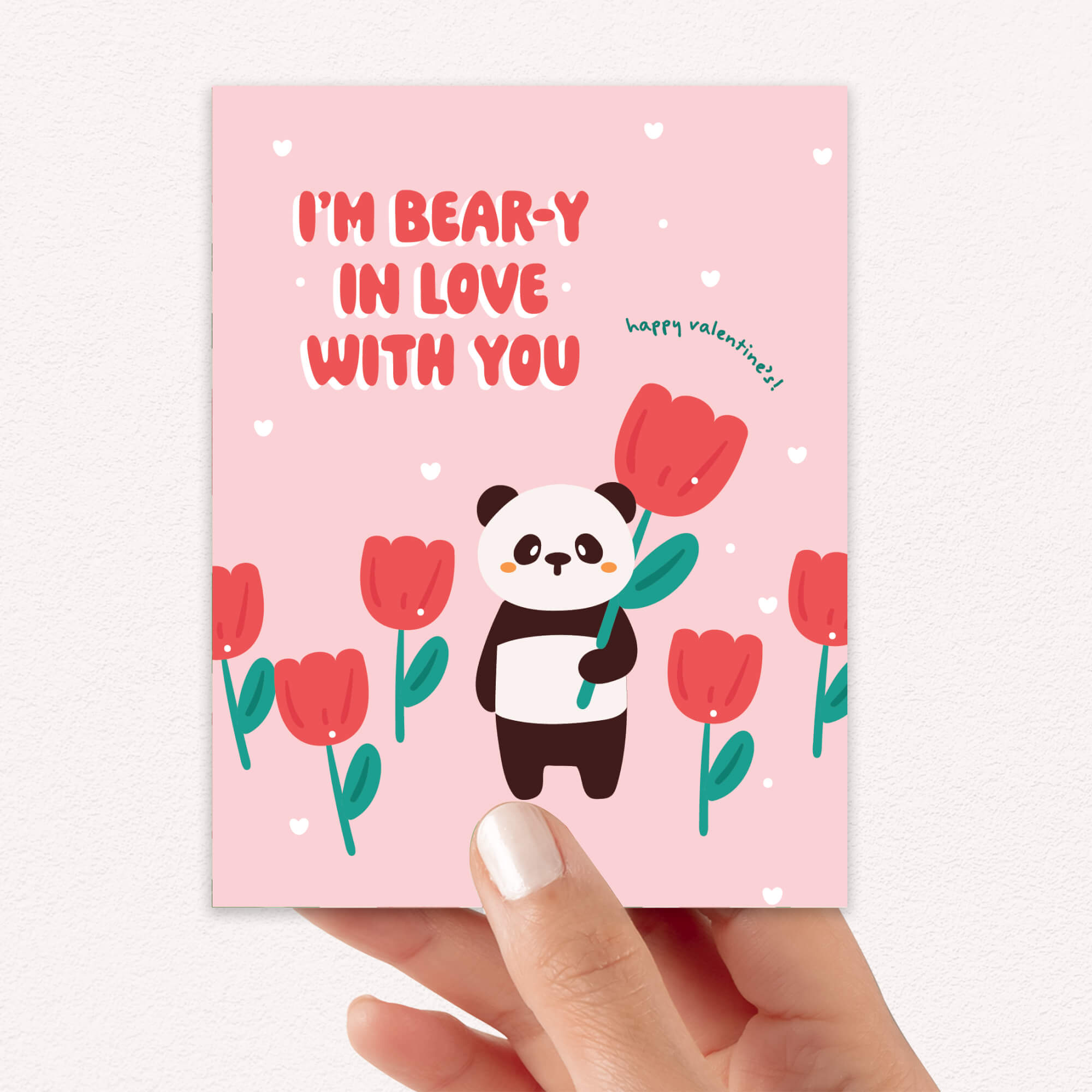 Panda holding tulip among pink flowers; text “I’m bear-y in love with you — happy valentine’s!”