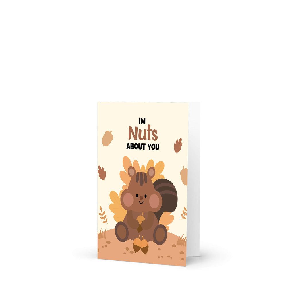 Greeting card with a cartoon squirrel holding a nut and text 'I'm Nuts About You' on a beige background.