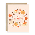 Thanksgiving card with fox, hedgehog, and pumpkins on a beige background