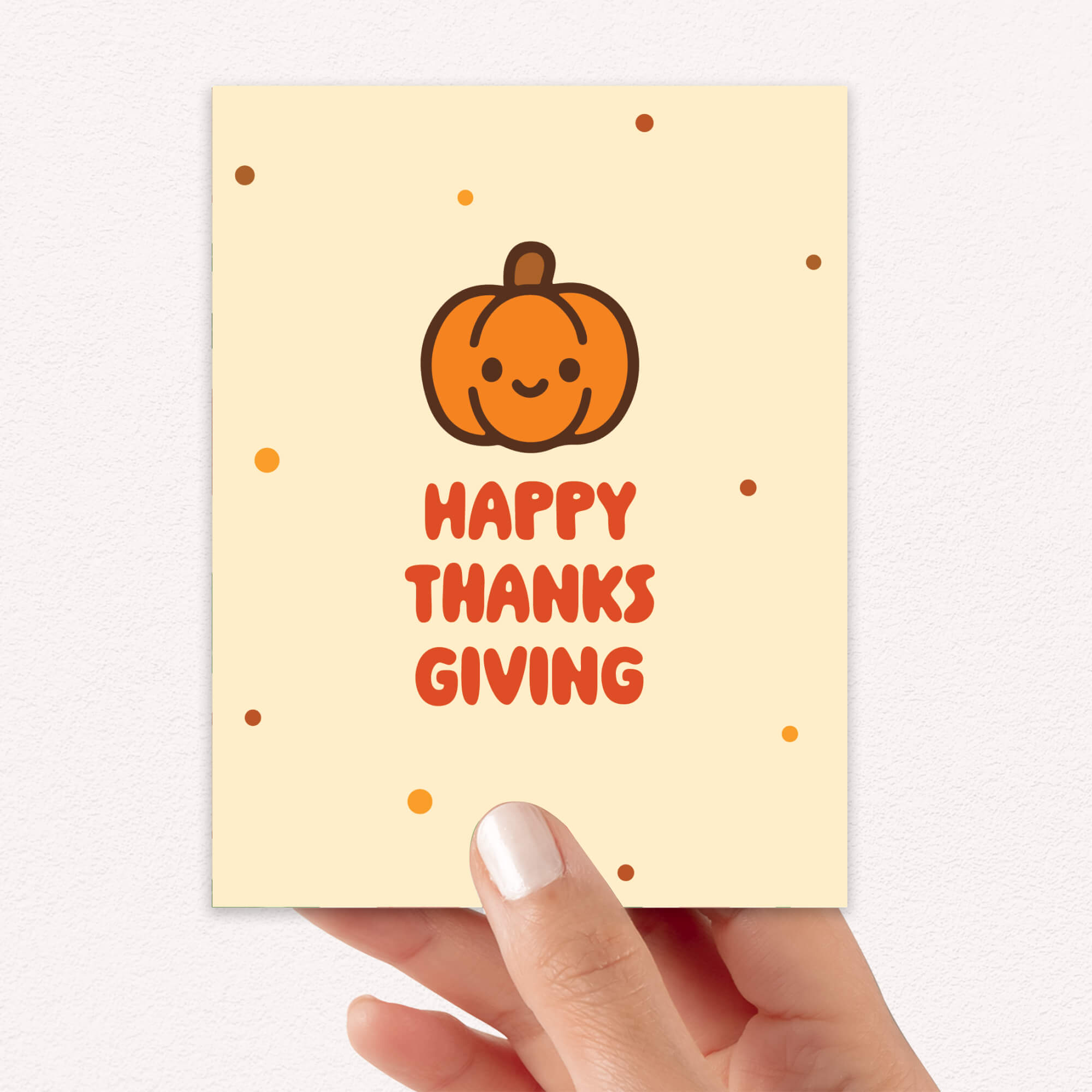 Happy Thanks Giving card with a pumpkin illustration held by a hand on a light background