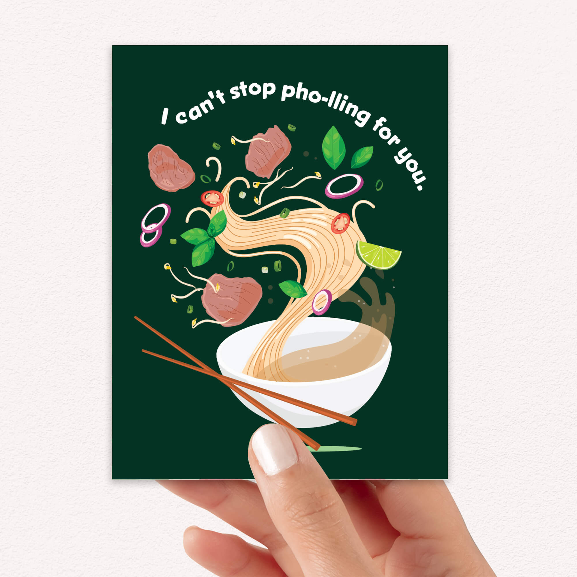 asian greeting card with a bowl of pho and chopsticks on a green background with text 'I can't stop pho-lling for you'.