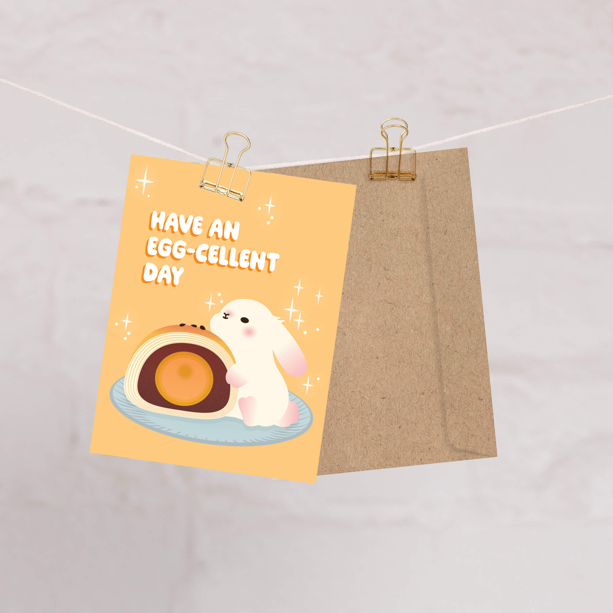 mid autumn festival Greeting card with a cute white bunny and egg yolk pastry, and text 'Have an EGG-cellent day' on a yellow background.