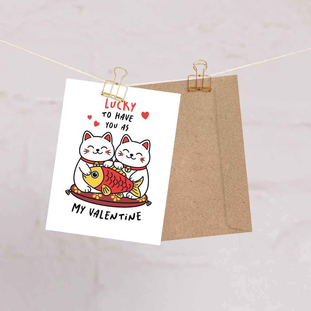 Valentine's Day card with two lucky maneki neko cats and a fish illustration, text 'Lucky to have you as my Valentine'.