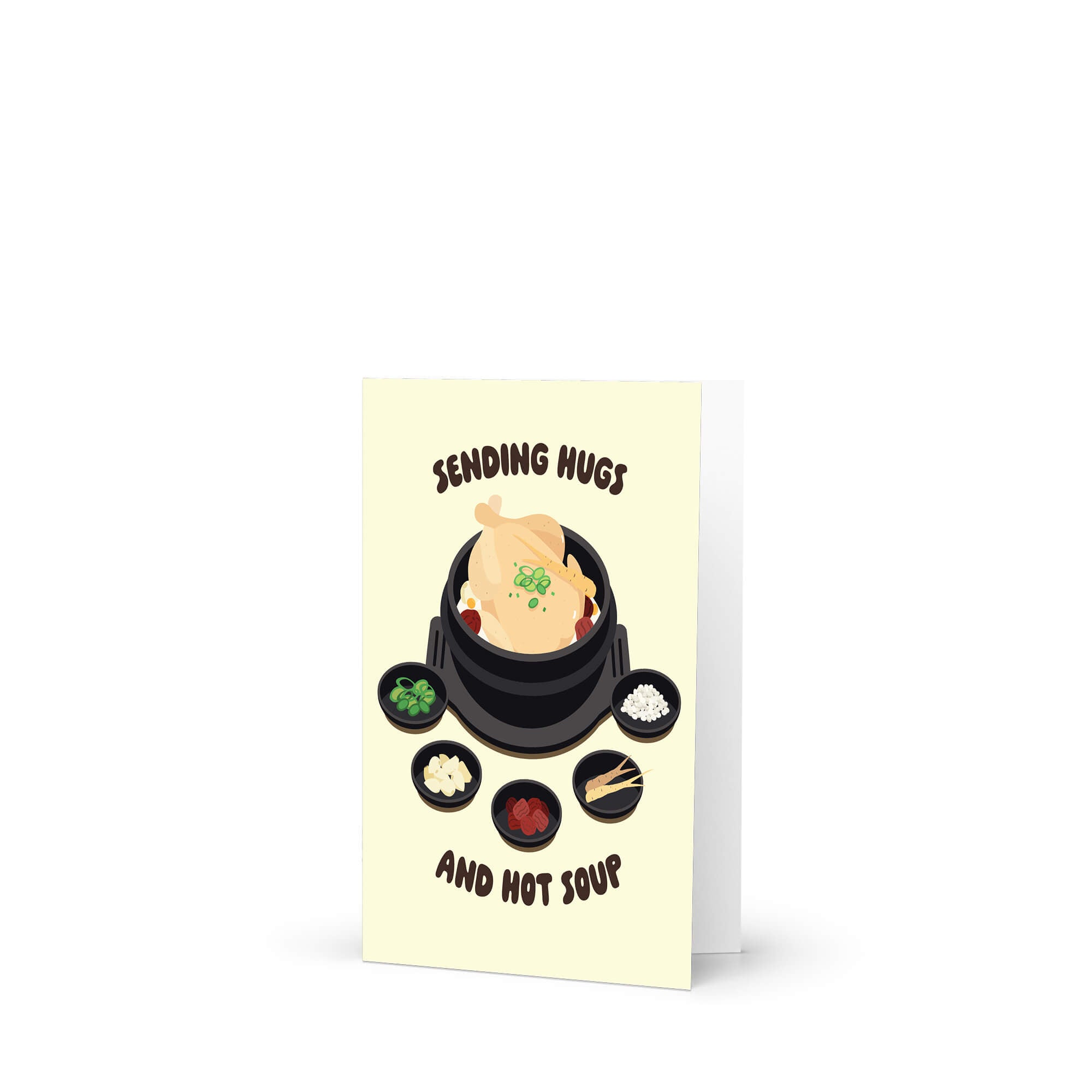asian Greeting card with a cartoon illustration of a korean chicken soup and text 'Sending Hugs and Hot Soup' on a beige background.