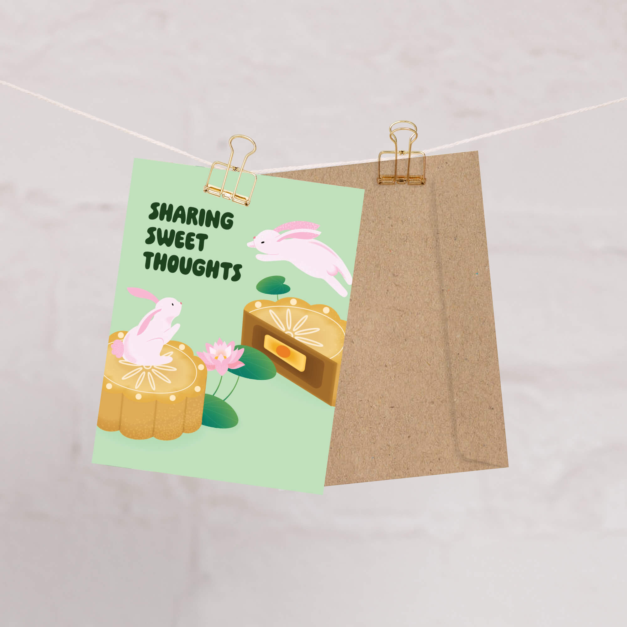 mid autumn greeting Card with cartoon bunnies and text 'Sharing Sweet Thoughts' on a string with a beige background