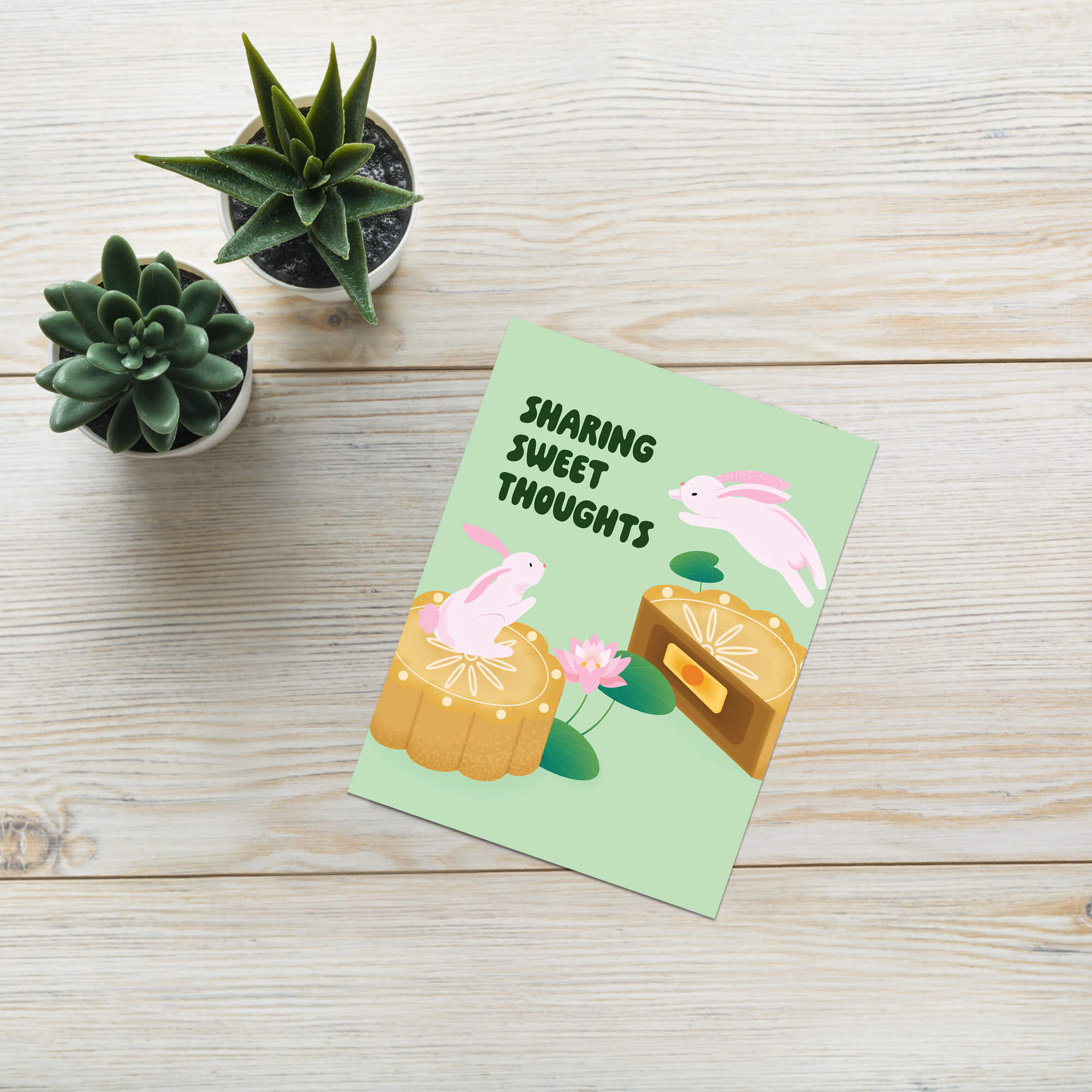 asian chinese mid autumn festival Greeting card with rabbits and mooncakes on a light green background