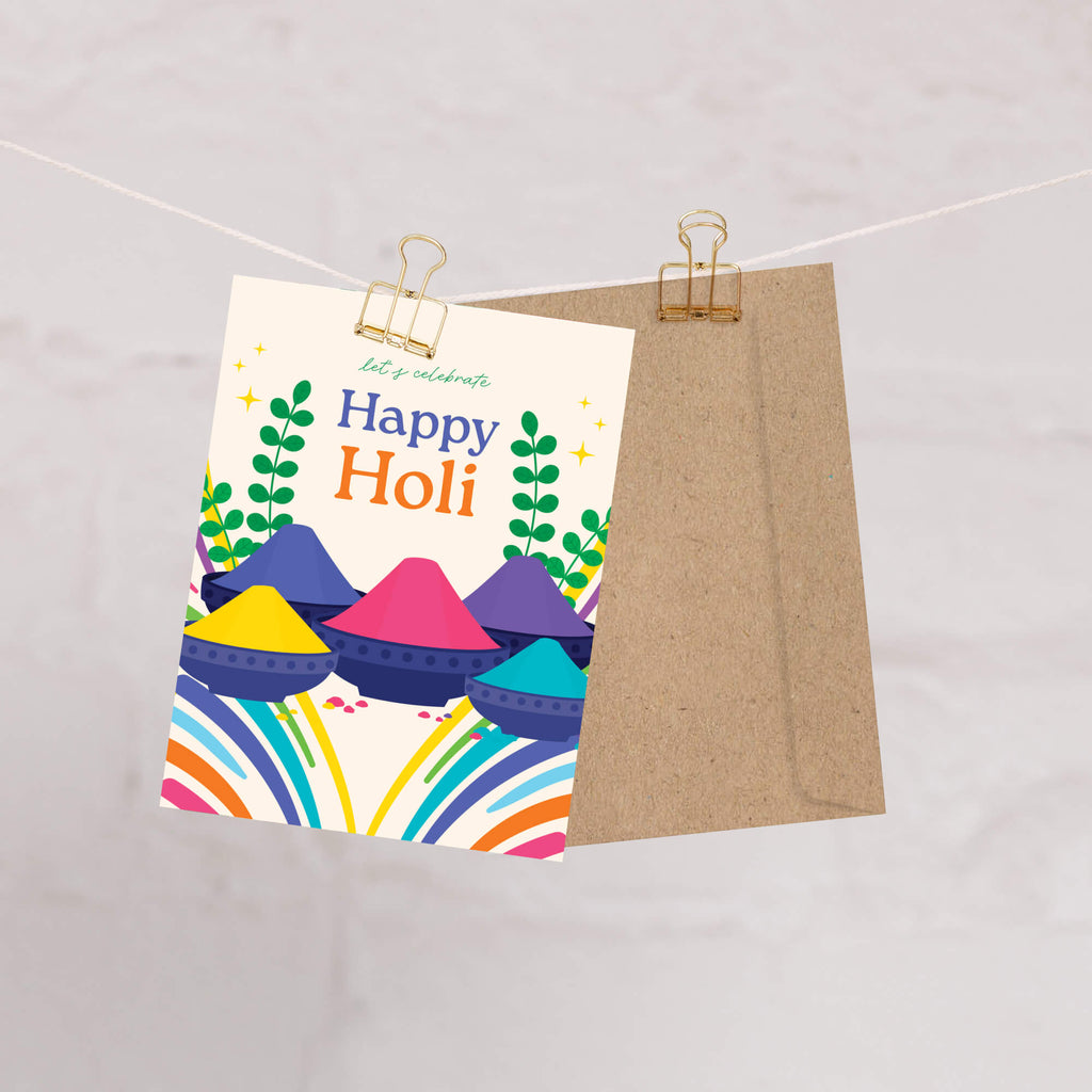 Colorful 'Happy Holi' card with traditional gulal on a beige background
