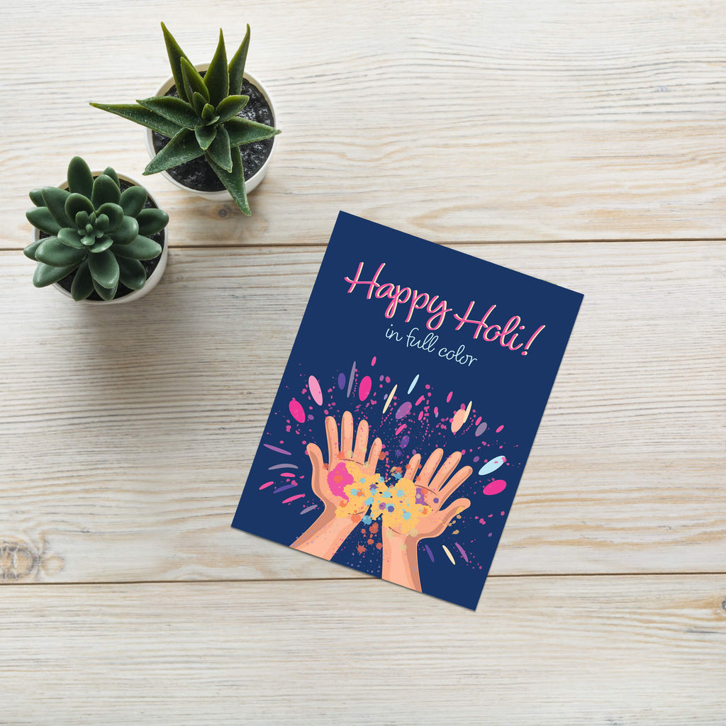 indian Greeting card with 'Happy Holi!' text and colorful hands holding gulal powder splashes on a blue background for the hindu festival of colors