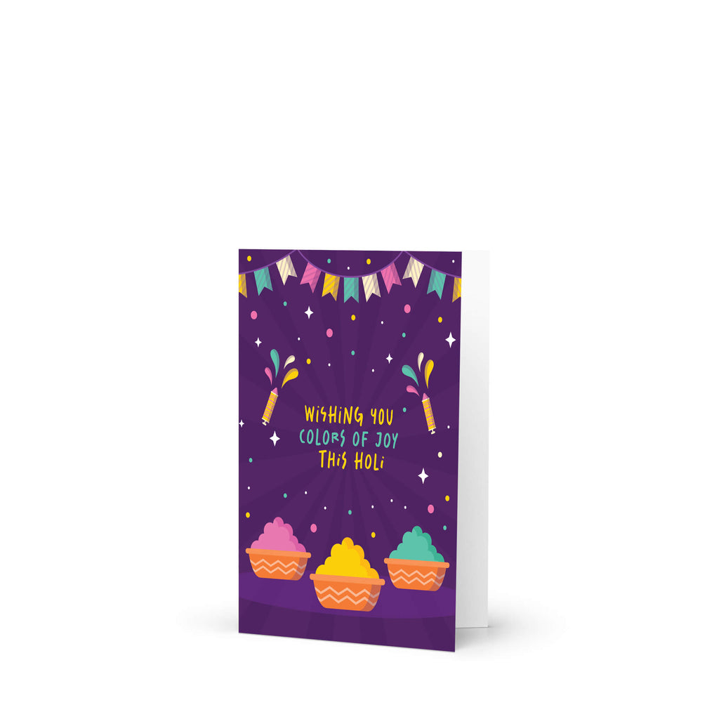 indian Greeting card with colorful design and text 'Wishing you colors of joy this Holi' on a purple background for hindu festival of colors