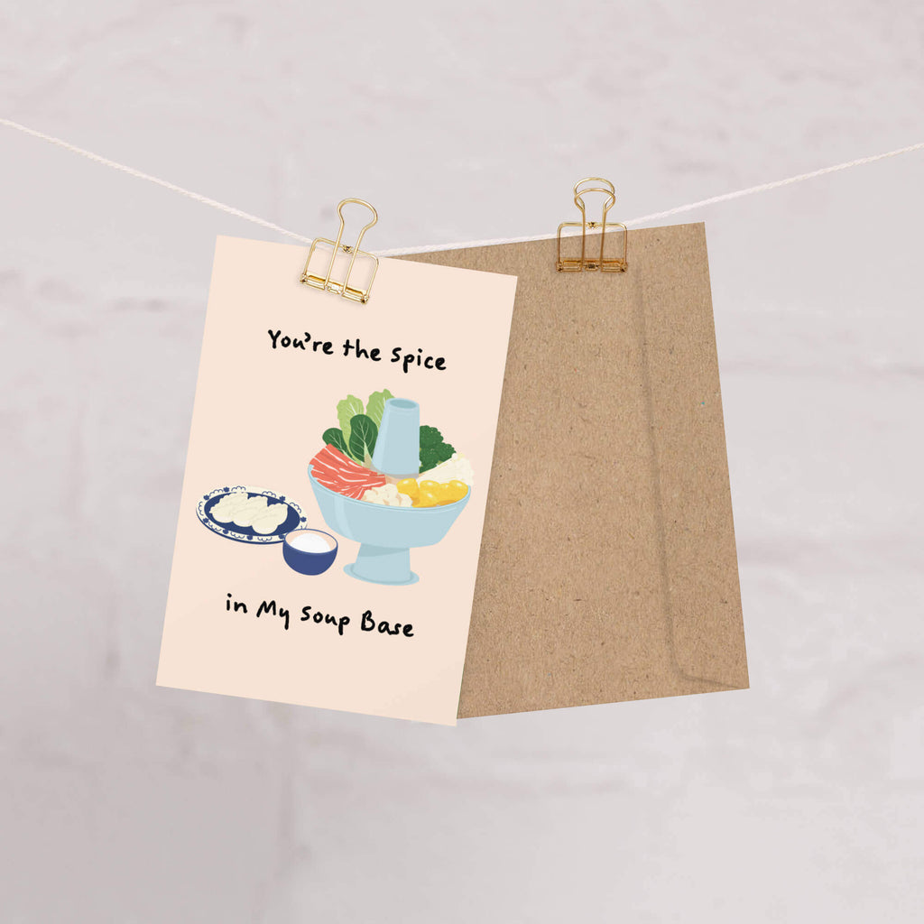 asian greeting card with illustration of a bowl of soup and text 'You're the Spice in My Soup Base' on a beige background.