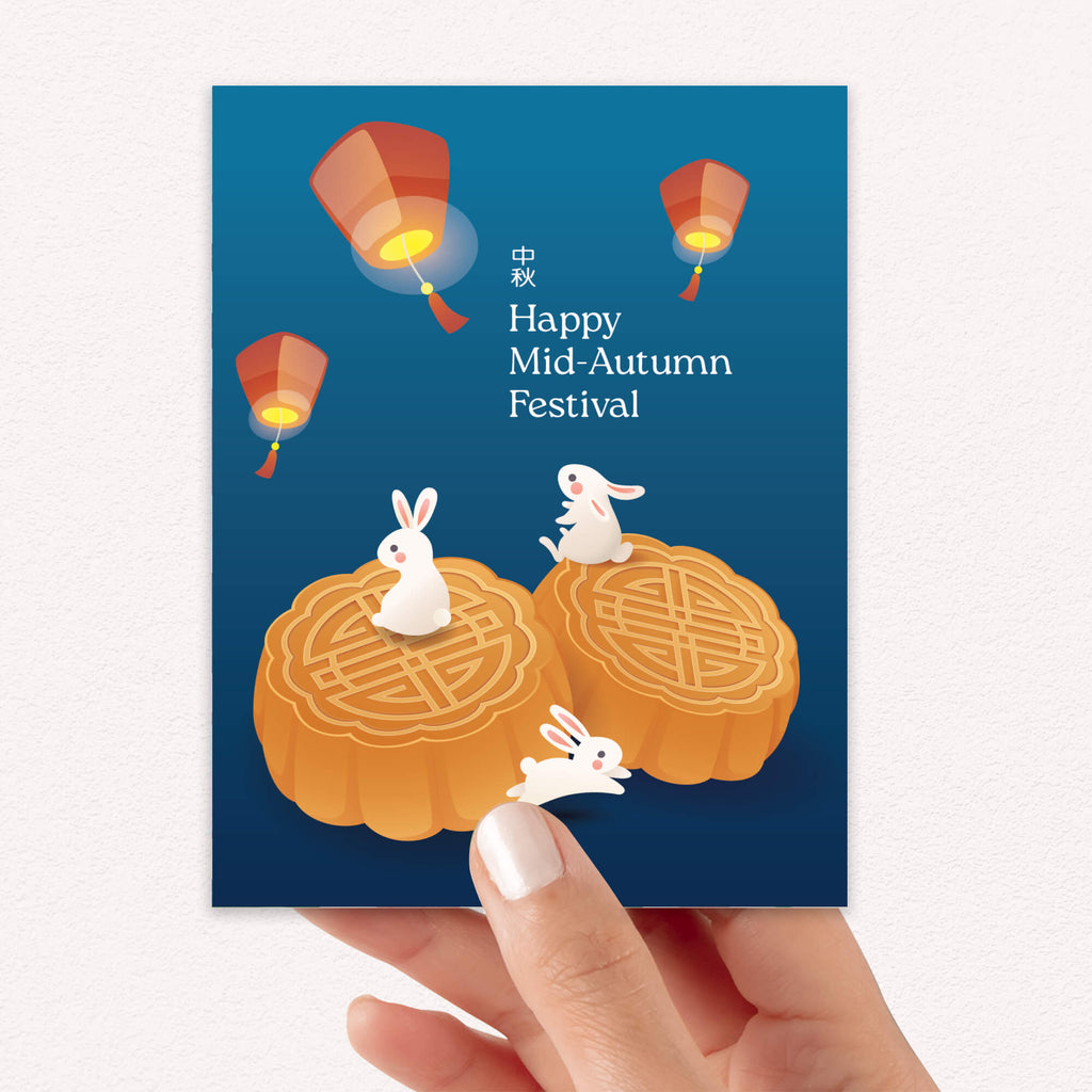asian inspired greeting Card with rabbits and mooncakes for the Mid-Autumn Festival on a blue background