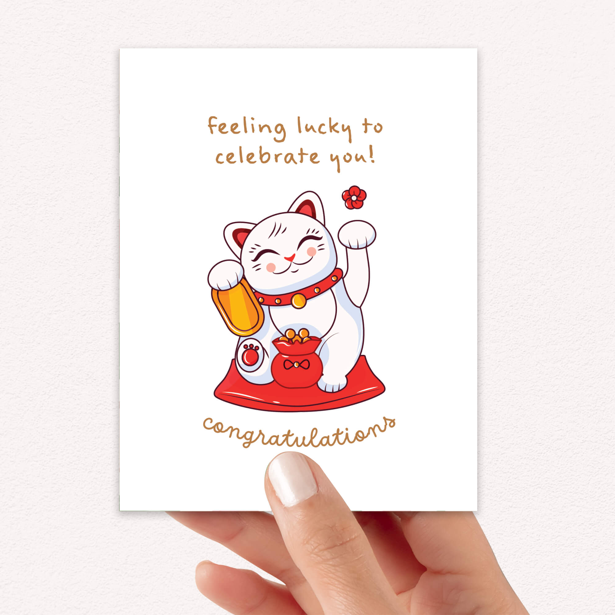 Greeting card with a japanese maneki neko lucky cat illustration and text on a white background that says "feeling lucky to celebrate you. congrats!"