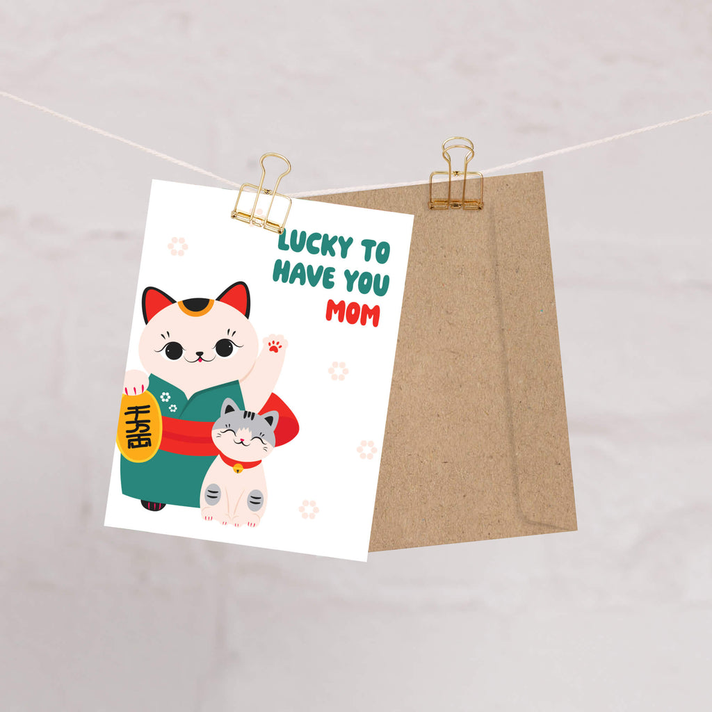 japanese Greeting card with 2 maneki neko lucky cats (mother and child) and text 'Lucky to have you mom' on a white background for a happy mother's day card
