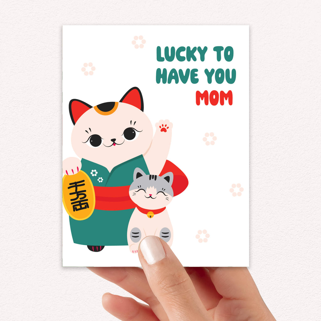 japanese Greeting card with 2 maneki neko lucky cats (mother and child) and text 'Lucky to have you mom' on a white background for a happy mother's day card