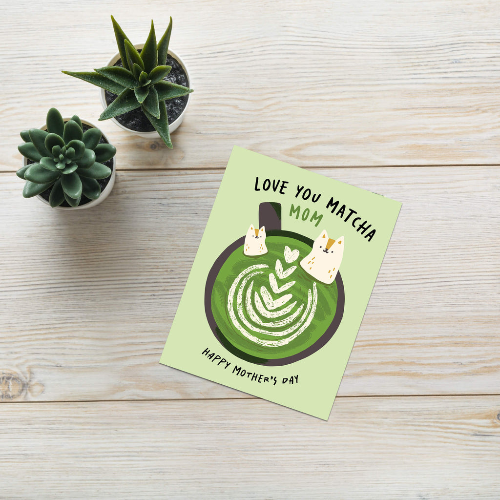 cute Mother's Day card with a green matcha latte design and text 'Love You Matcha Mom Happy Mother's Day' on a light green background and two cats in cup