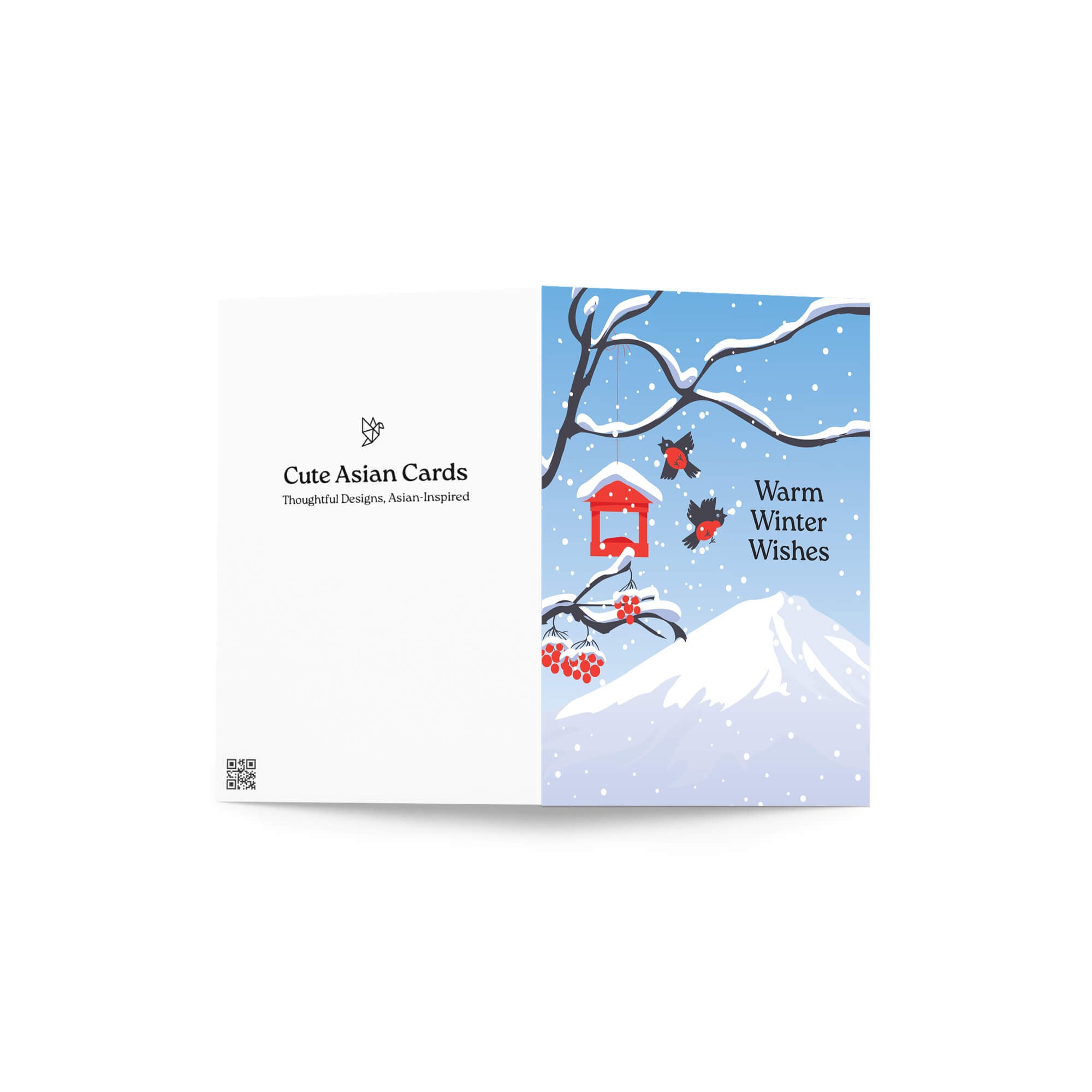 unique japanese christmas card. Snow-covered tree branches with red berries, birds, a red birdhouse, and Mt. Fuji. Text reads “Warm Winter Wishes.”