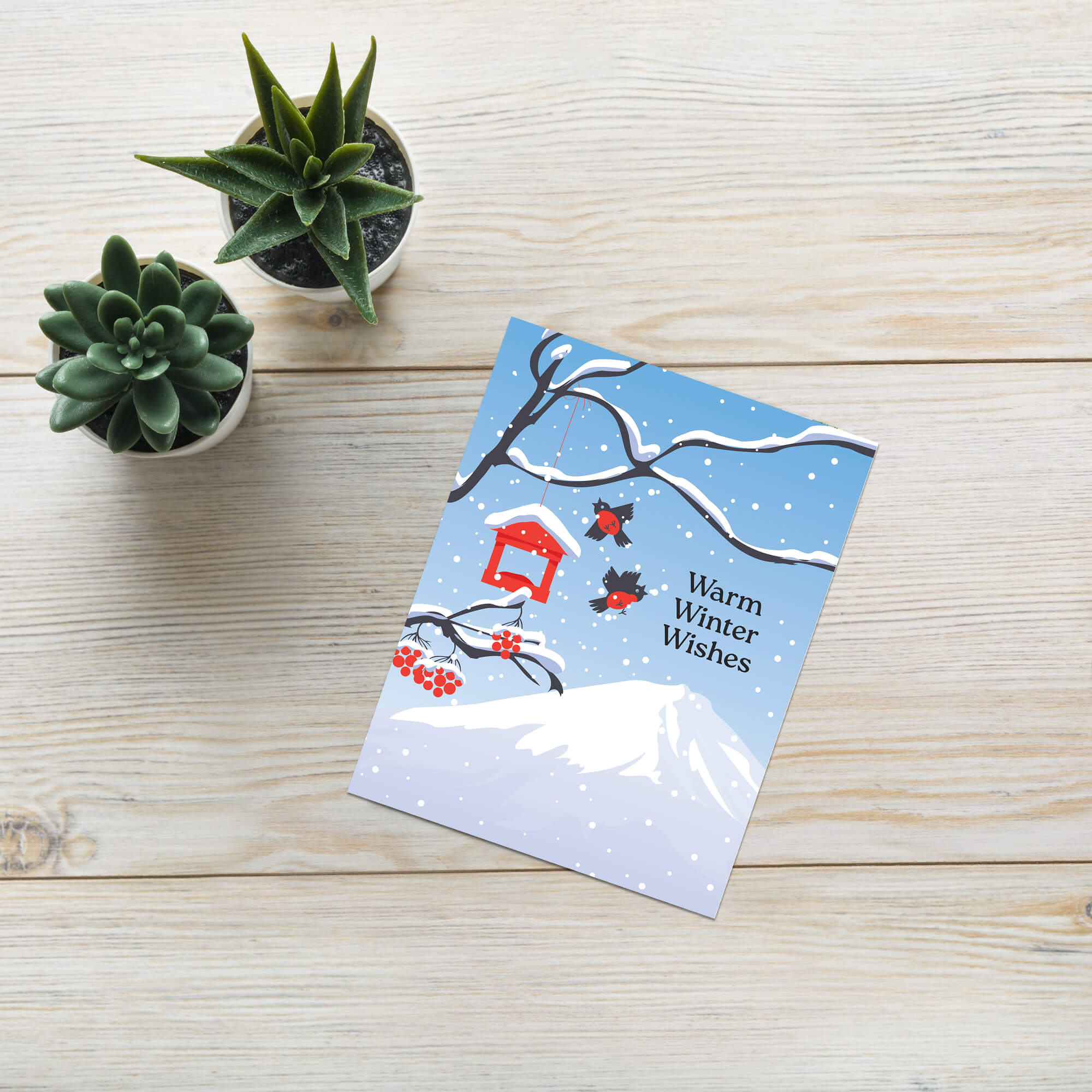 unique japanese christmas card. Snow-covered tree branches with red berries, birds, a red birdhouse, and Mt. Fuji. Text reads “Warm Winter Wishes.”