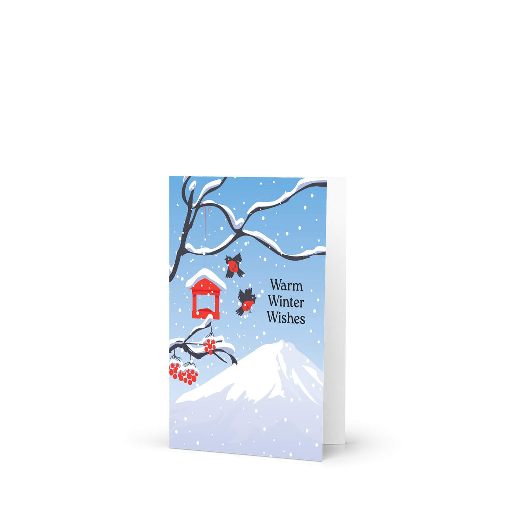 unique japanese christmas card. Snow-covered tree branches with red berries, birds, a red birdhouse, and Mt. Fuji. Text reads “Warm Winter Wishes.”