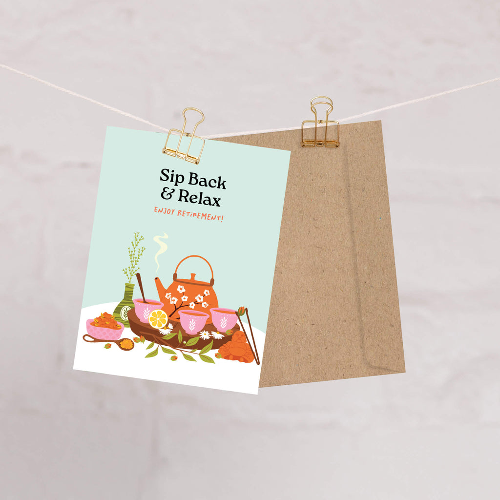 Tea-themed greeting card with teapot illustration and 'Sip Back & Relax' text, attached to a string with a clip.