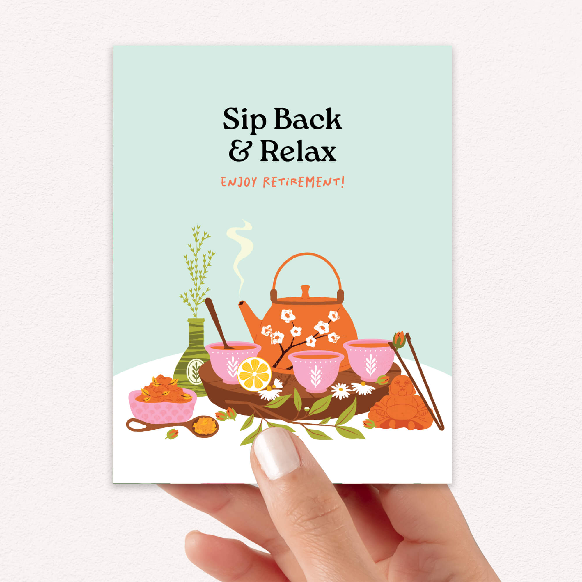 Greeting card with teapot illustration and 'Sip Back & Relax' text on a light blue background.