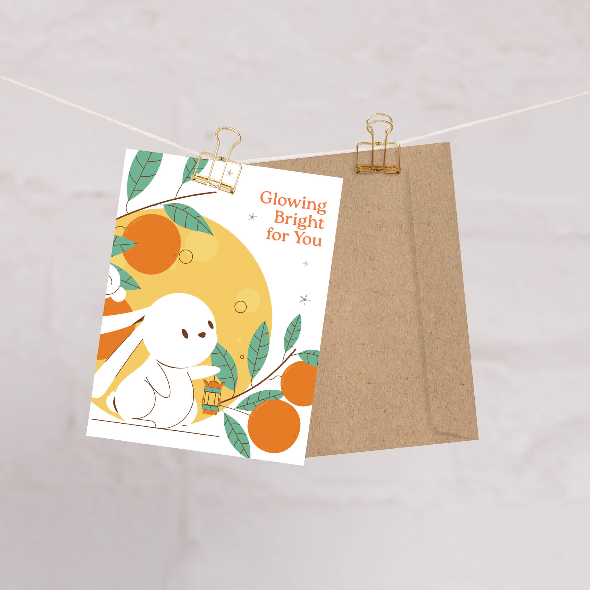 mid autumn festival Greeting card with a cartoon character and oranges, attached to a string with a clip.