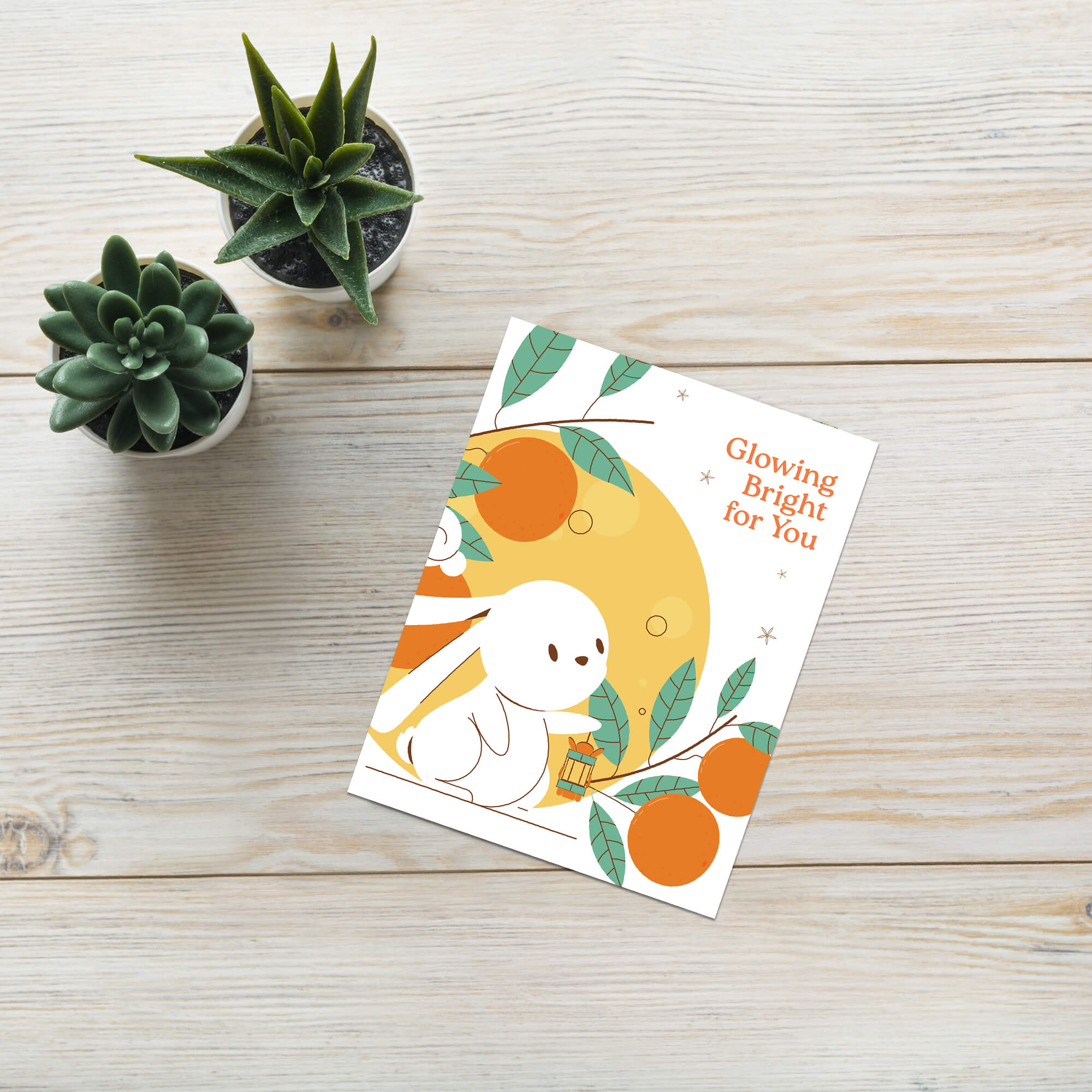 cute asian Greeting card with a white rabbit, orange fruits, and leaves on a white background