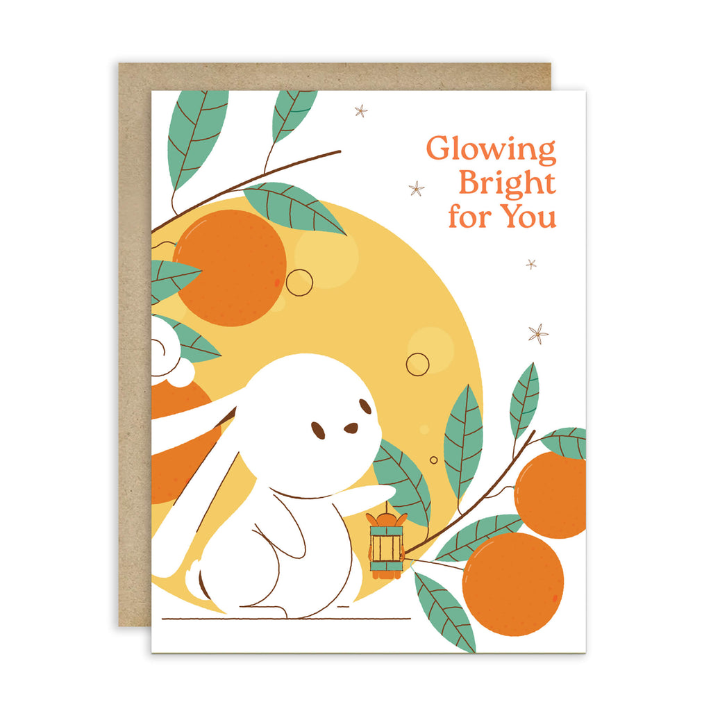 cute asian Greeting card with a white rabbit, orange fruits, and leaves on a white background