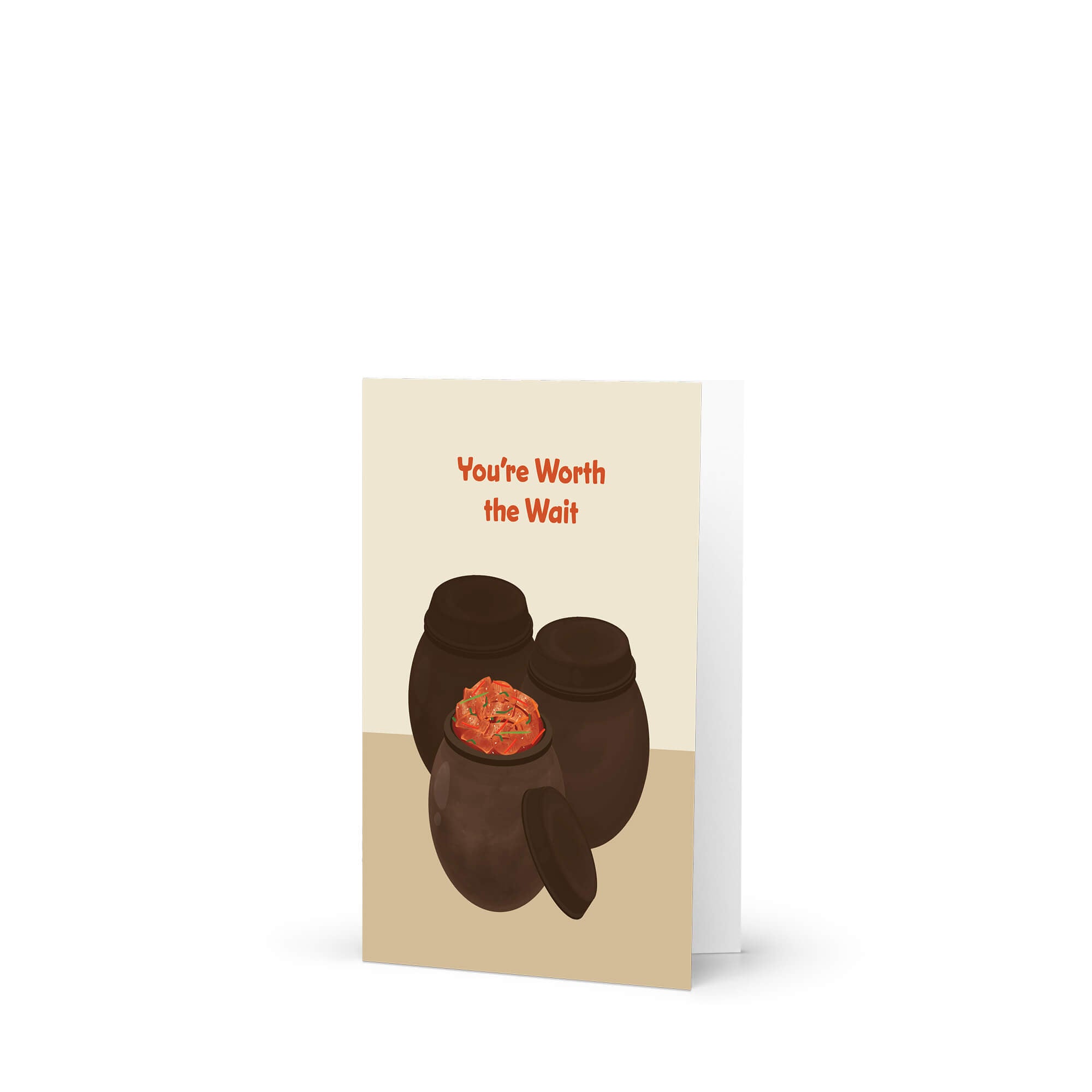 Greeting card with two traditional korean fermenting pots and a kimchi cabbage inside, text 'You're Worth the Wait' on a beige background.