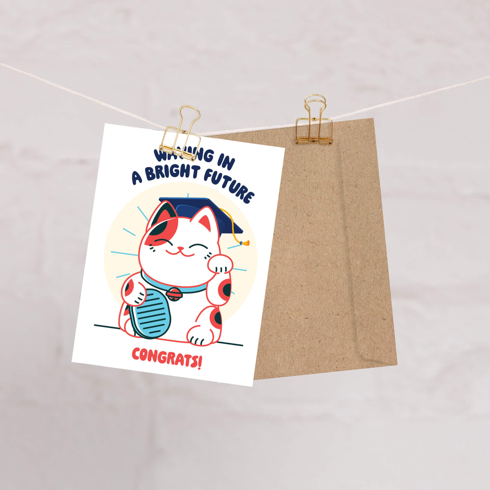 cute graduation card with a japanese lucky cat in a graduation cap and tassel, text 'Waving in a Bright Future' and 'Congrats!' on a white background.