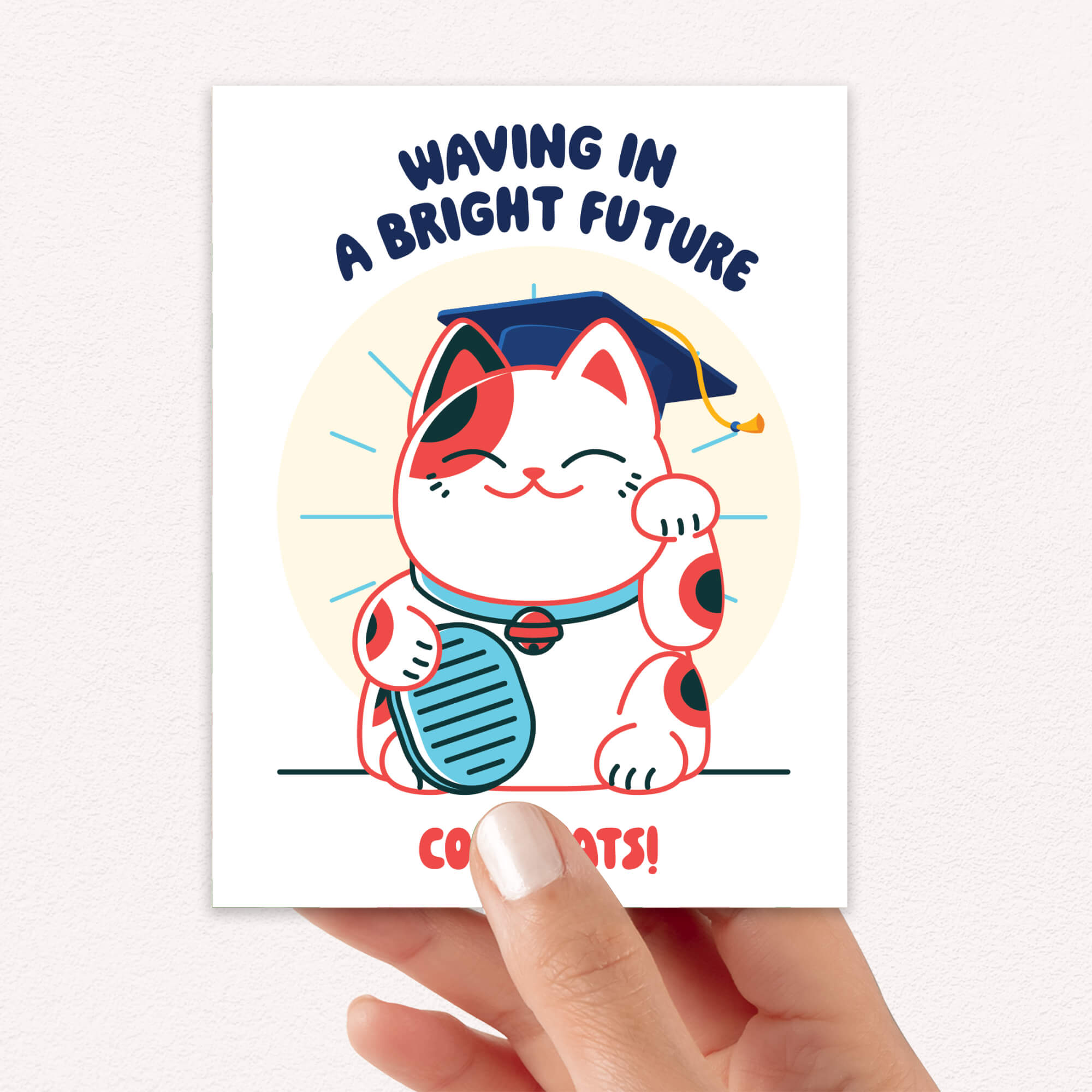 cute graduation card with a japanese lucky cat in a graduation cap and tassel, text 'Waving in a Bright Future' and 'Congrats!' on a white background.