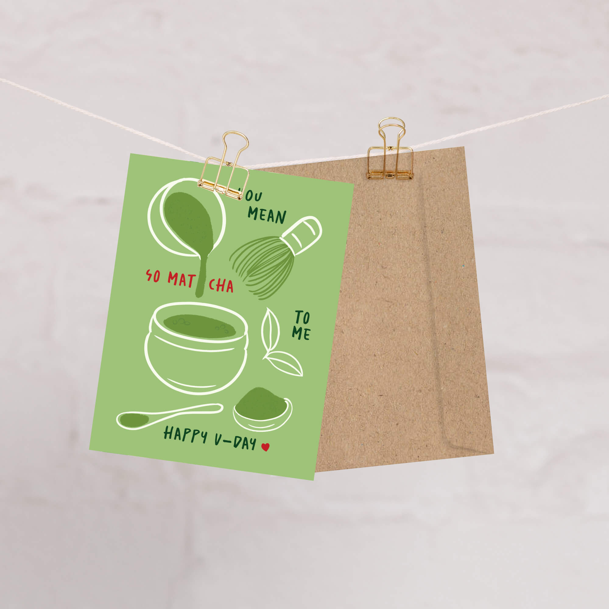 Matcha whisk, bowl, and scoop on sage background with “You mean so matcha to me.”