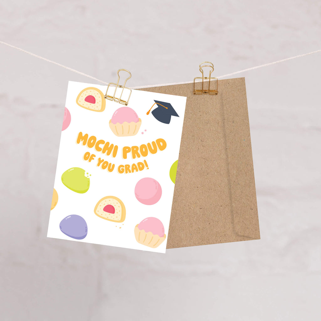 Graduation card with japanese mochi illustrations and text 'Mochi Proud of You Grad!' on a white background.